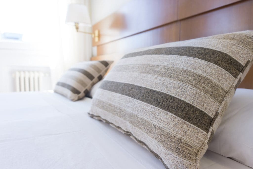 white and grey bed linens create bedroom bliss