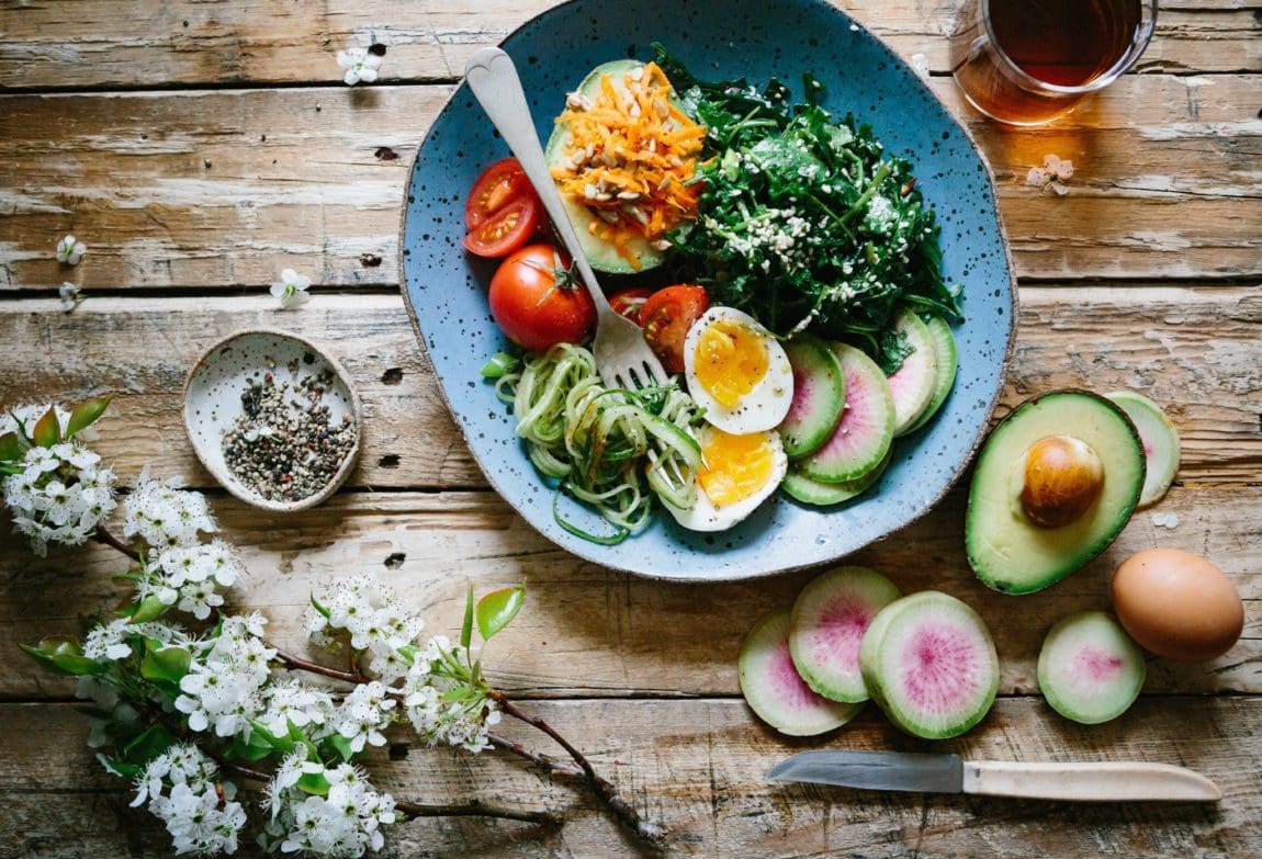 a bowl of colorful vegetables and eggs