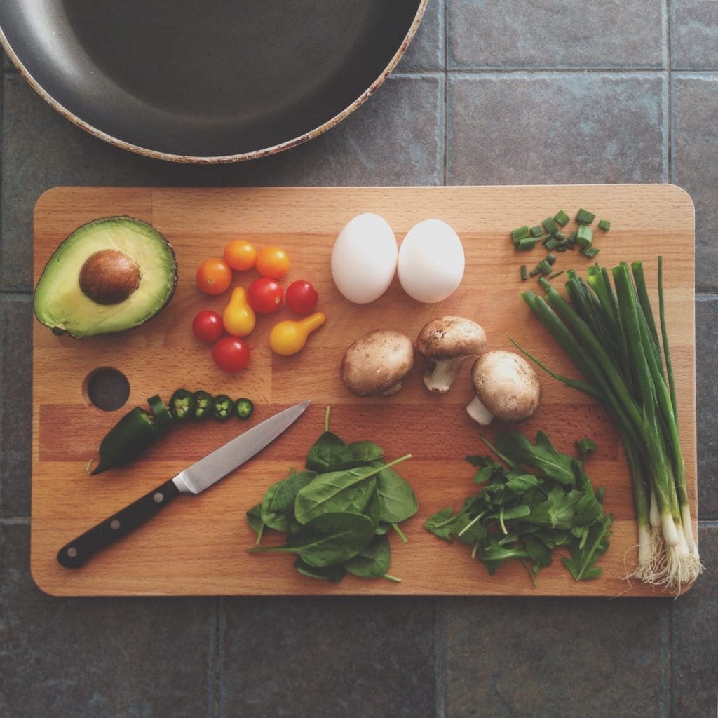 meal prep for the week: a cutting board with vegetables and herbs