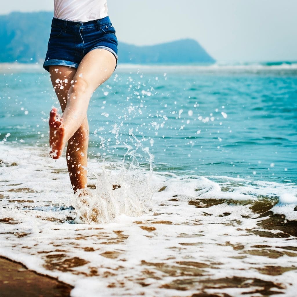 a woman splashing in the waves