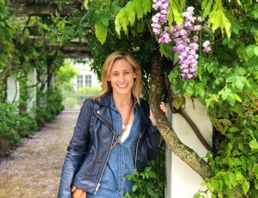 Merry Lerner standing under a trellis