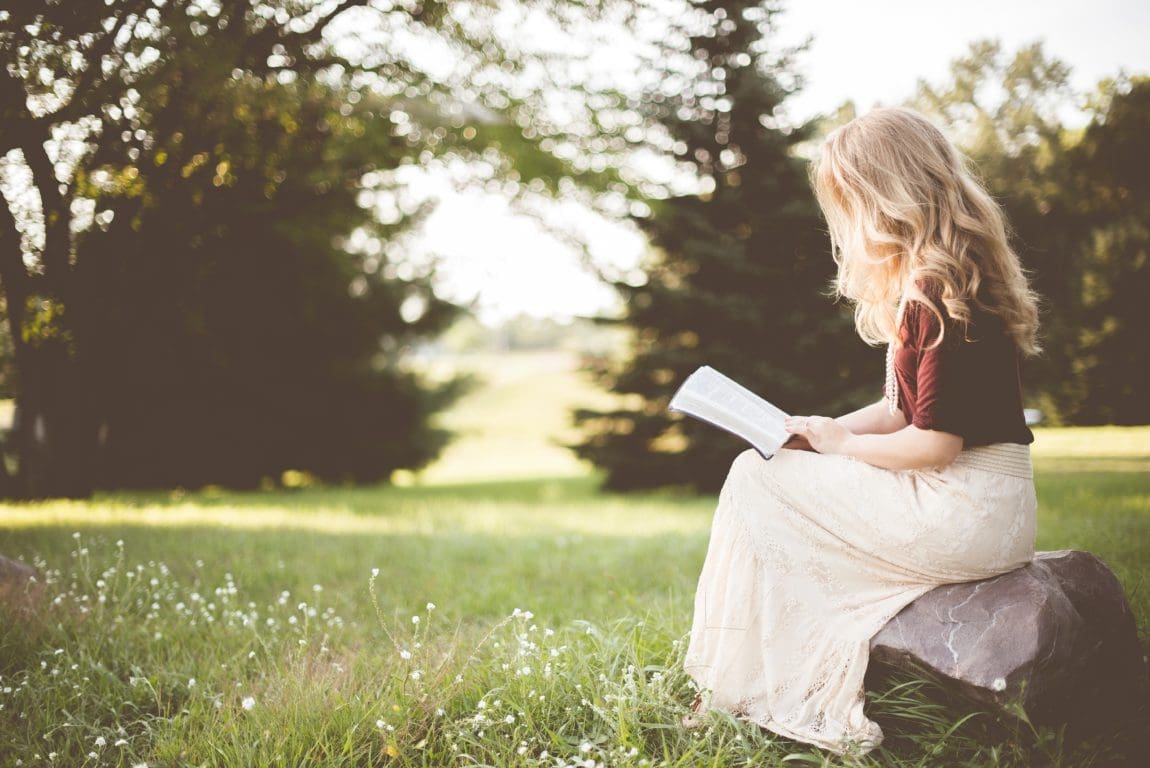 a woman sitting reading a book